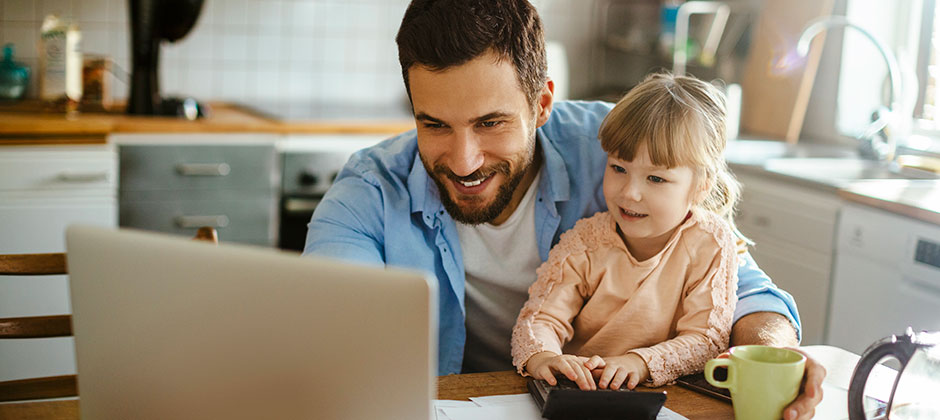 Parent online with child on lap, happy